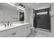 Modern bathroom with double vanity, sleek tile shower, and contemporary fixtures at 143 Mills Garden Rd, Statesville, NC 28625