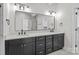 Modern bathroom featuring a double vanity with a sleek, dark wood cabinet and rectangular mirror at 143 Mills Garden Rd, Statesville, NC 28625