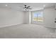 Spacious bedroom with plush carpeting, recessed lighting, and a large window for plenty of natural light at 143 Mills Garden Rd, Statesville, NC 28625