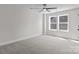 Comfortable bedroom features soft carpeting, large window, and a modern ceiling fan at 143 Mills Garden Rd, Statesville, NC 28625