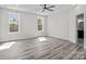 Spacious bedroom with wood-look flooring and large windows offering abundant natural light at 143 Mills Garden Rd, Statesville, NC 28625