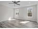 Bright bedroom features wood-look flooring, two large windows and a ceiling fan at 143 Mills Garden Rd, Statesville, NC 28625