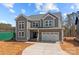 Beautiful exterior of a two-story home showcasing a two-car garage, covered entry, and stylish curb appeal at 143 Mills Garden Rd, Statesville, NC 28625