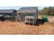 Two-story home featuring a charming front porch and neutral gray siding, set on spacious lot at 143 Mills Garden Rd, Statesville, NC 28625