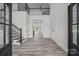 Bright open foyer featuring wood flooring, stairs to the upper level, and views through to the back patio at 143 Mills Garden Rd, Statesville, NC 28625