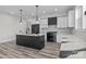 Modern kitchen featuring an island with stylish countertop, white cabinets, and wood floors at 143 Mills Garden Rd, Statesville, NC 28625