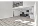 Open-concept living room showcases sleek wood floors, a staircase, and a modern kitchen with a large island at 143 Mills Garden Rd, Statesville, NC 28625