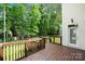 A wood deck features a stained wood railing overlooking a green lawn at 15001 Arrowgrass Way, Charlotte, NC 28278