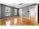 Bright bedroom features hardwood floors and two large windows offering ample natural light at 15001 Arrowgrass Way, Charlotte, NC 28278