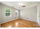 Light-filled bedroom with hardwood floors, two windows and neutral paint at 15001 Arrowgrass Way, Charlotte, NC 28278