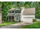 Charming two-story home with black shutters, brick accents and a lush green lawn at 15001 Arrowgrass Way, Charlotte, NC 28278