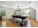 Bright game room features a billiard table, hardwood floors, and natural light from large windows at 15001 Arrowgrass Way, Charlotte, NC 28278