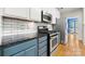 Galley kitchen boasts subway tile backsplash, stainless steel oven and microwave at 15001 Arrowgrass Way, Charlotte, NC 28278