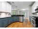 Stylish kitchen features shaker cabinets, stainless steel appliances, granite countertops and a view to the living room at 15001 Arrowgrass Way, Charlotte, NC 28278