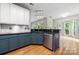 Bright kitchen with shaker cabinets, stainless steel appliances, granite countertops and hardwood floors at 15001 Arrowgrass Way, Charlotte, NC 28278