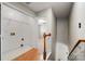 Upstairs landing showing laundry room and entry to an upstairs bedroom at 15001 Arrowgrass Way, Charlotte, NC 28278