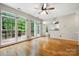Open living room boasts large windows providing ample light and views of the backyard at 15001 Arrowgrass Way, Charlotte, NC 28278