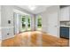 Sunlit living room with hardwood floors, bay windows and a door to the kitchen at 15001 Arrowgrass Way, Charlotte, NC 28278