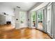 Living room featuring a door to an outdoor deck, large windows, and a view of the fireplace at 15001 Arrowgrass Way, Charlotte, NC 28278