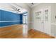 Bright living room with hardwood floors, a ceiling fan, and views of the foyer and bay window at 15001 Arrowgrass Way, Charlotte, NC 28278