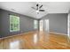Bright, airy main bedroom with ceiling fan and natural light from large windows at 15001 Arrowgrass Way, Charlotte, NC 28278