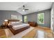 Spacious main bedroom boasts vaulted ceiling, fan, and natural light from two large windows overlooking landscaped yard at 15001 Arrowgrass Way, Charlotte, NC 28278