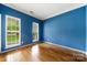 Bright office space with hardwood floors, blue walls and ample natural light at 15001 Arrowgrass Way, Charlotte, NC 28278
