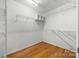 Walk-in closet with built-in shelving, providing ample storage space at 15001 Arrowgrass Way, Charlotte, NC 28278