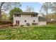 Lush backyard features outdoor dining area and well-maintained lawn at 1555 Ridgewood Dr, Gastonia, NC 28054