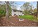 Spacious backyard with a fire pit, patio, and lush green lawn at 1555 Ridgewood Dr, Gastonia, NC 28054