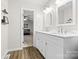 Bright double sink bathroom with tile floors, and access to the main bedroom at 1555 Ridgewood Dr, Gastonia, NC 28054