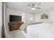 Neutral bedroom showcasing a ceiling fan, full dresser with television, and doors to the bathroom and closet at 1555 Ridgewood Dr, Gastonia, NC 28054