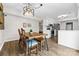 Cozy dining area with wood floors, stylish seating, and an adjacent kitchen, ideal for casual meals at 1555 Ridgewood Dr, Gastonia, NC 28054