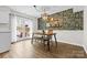Charming dining room featuring decorative wallpaper, wood floors, and sliding glass doors to outdoor patio at 1555 Ridgewood Dr, Gastonia, NC 28054