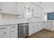 Bright kitchen with quartz countertops, a stainless steel dishwasher, and ample cabinet space at 1555 Ridgewood Dr, Gastonia, NC 28054