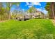 Lush, well-maintained lawn leads up to a beautiful yellow home with a backyard deck at 158 Regency Rd, Mooresville, NC 28117