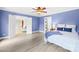 Blue bedroom featuring hardwood floors, closet, and views into adjacent living spaces at 158 Regency Rd, Mooresville, NC 28117