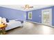 Blue bedroom includes hardwood floors, ceiling fan and an exterior glass door to the lake at 158 Regency Rd, Mooresville, NC 28117