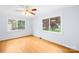 Bright bedroom featuring wood floors, ceiling fan, and large windows providing natural light at 158 Regency Rd, Mooresville, NC 28117