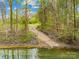 Scenic view of a private boat ramp leading to a tranquil waterfront surrounded by lush greenery at 158 Regency Rd, Mooresville, NC 28117