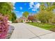Charming home showcasing a manicured lawn, mature trees, and a long driveway leading to a lovely facade at 158 Regency Rd, Mooresville, NC 28117
