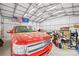 Spacious garage interior with a red truck parked inside, illuminated by bright overhead lighting at 158 Regency Rd, Mooresville, NC 28117
