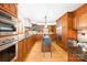 Spacious kitchen featuring custom wood cabinetry, stainless steel appliances, and a central island at 158 Regency Rd, Mooresville, NC 28117