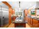 Gourmet kitchen with granite island, stainless fridge, and seamless access to other living spaces at 158 Regency Rd, Mooresville, NC 28117
