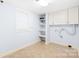 Bright laundry room features built-in cabinets and open shelving for ample storage solutions at 158 Regency Rd, Mooresville, NC 28117