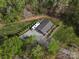 Aerial shot showcasing a detached structure with an RV parked outside, amidst lush trees at 1725 Hannon Farm Rd, Fort Mill, SC 29715