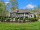 Expansive backyard view showcasing the home's back exterior and an in-ground pool surrounded by lush landscaping at 1725 Hannon Farm Rd, Fort Mill, SC 29715