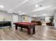 Finished basement featuring a pool table, seating area with TV, and laminate flooring at 1725 Hannon Farm Rd, Fort Mill, SC 29715