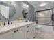 Well-lit bathroom featuring a double sink vanity, elegant mirrors, and a modern glass-enclosed shower at 1725 Hannon Farm Rd, Fort Mill, SC 29715