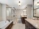 Luxurious bathroom with a soaking tub, walk-in shower, dual sinks, and elegant fixtures at 1725 Hannon Farm Rd, Fort Mill, SC 29715